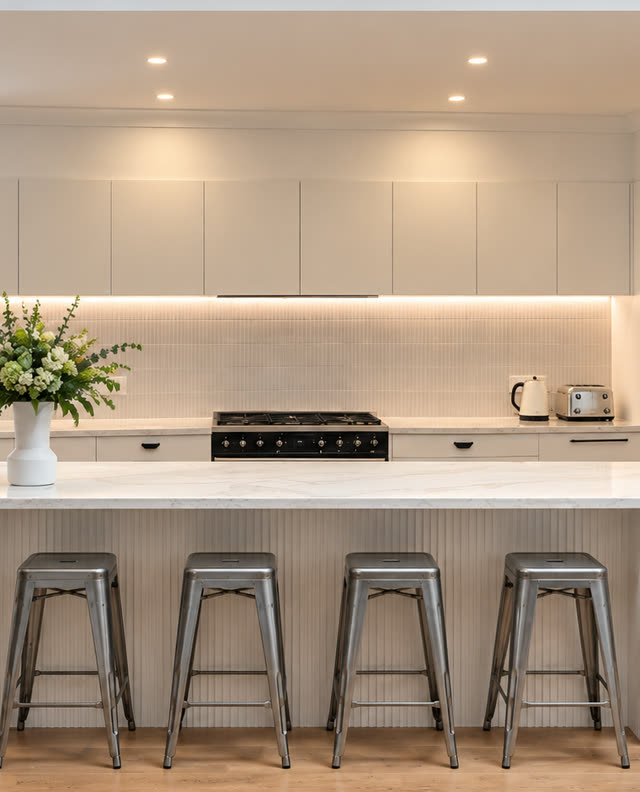 Modern kitchen with a fluted island, marble benchtops and oak floors
